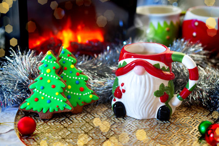 colorful gingerbread cookies and a cup of hot chocolate. A view through a snowy windowの写真素材