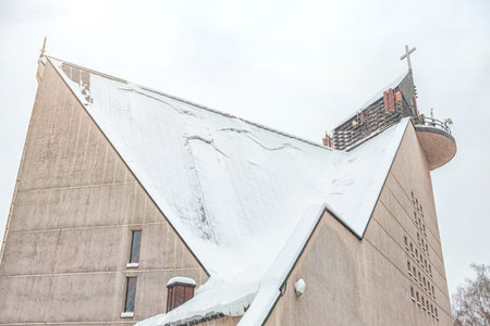 snowy church after a blizzard, avalanche danger, snow falling from the roofの写真素材