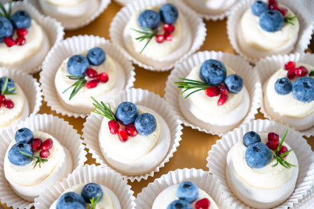 Delicious Mini Desserts Topped With Blueberries and Raspberries on a Decorative Platter