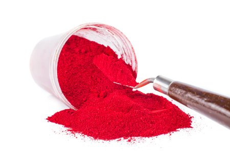 Bright Red Pigment Spilled From Container With a Spatulaの写真素材