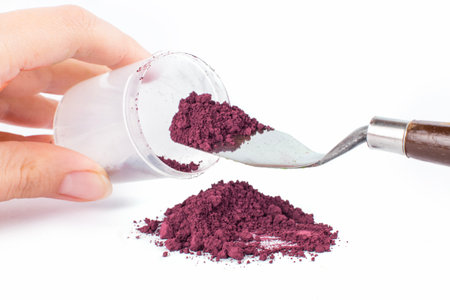 Powder Being Scooped From a Container With a Knife for Crafting or Artistic Projectsの写真素材