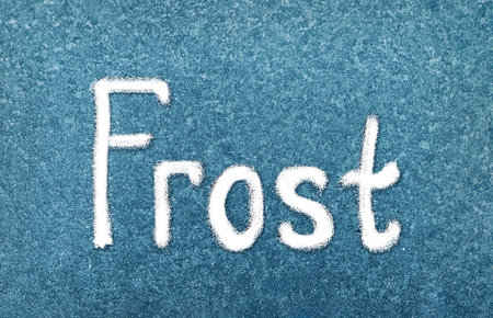 Frost Written in White on a Blue Background, Showcasing the Beauty of Winters Touch on Surfacesの写真素材