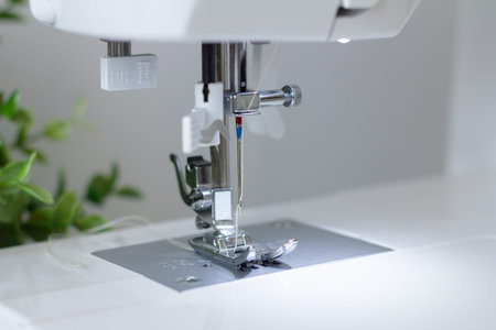 close up detail of modern sewing machine needle. selective focus