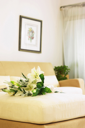A bouquet of flowers on the couchの写真素材