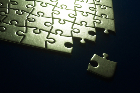 Studio shot of an uncomplete jigsaw puzzle on a black backgroundの写真素材