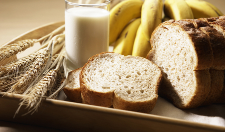 Wholemeal breads with bananas and a glass of milkの写真素材