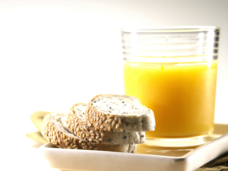 Wholemeal bread and a glass of orange juiceの写真素材