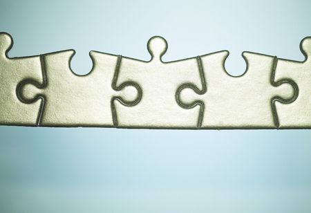 Close-up picture of an assemblance of jigsaw puzzle piecesの写真素材