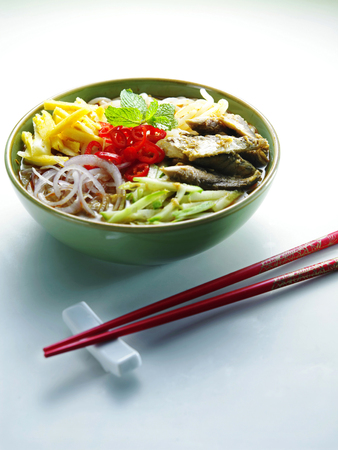 Malaysia food- bowl of assam laksa with a pair of red chopsticks by the sideの写真素材