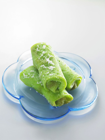 Malaysia food-Three rolls of kueh gulung on a flower-shaped plateの写真素材