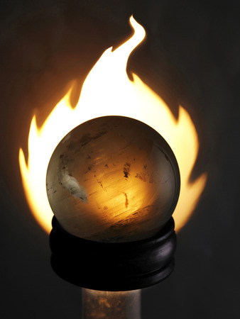 A crystal ball in front of the fireの写真素材