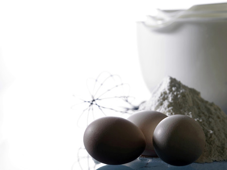Close up of eggs,flour and the mixing bowlsの写真素材
