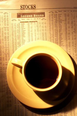 A cup of coffee on a newspaperの写真素材