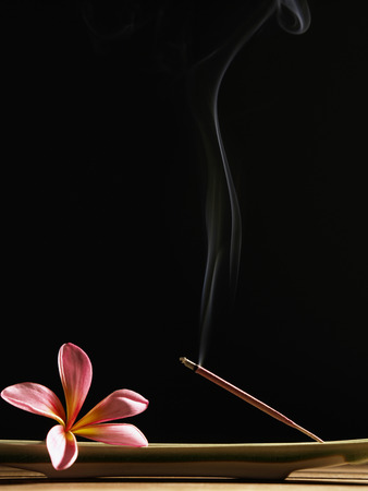 Smoke coming out from a burning incenseの写真素材