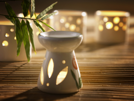 Essential oil burner with tea light candles in backgroundの写真素材