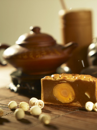 moon cake with tea pot as backgroundの写真素材