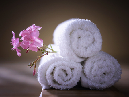 Rolled up towels with flowerの写真素材
