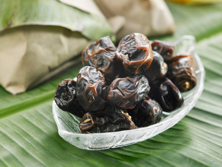 bowl of the dates on the banana leaf