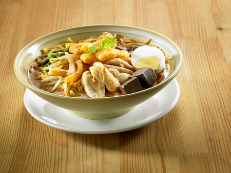 malaysian food bowl of the curry noodle on the wooden tableの写真素材