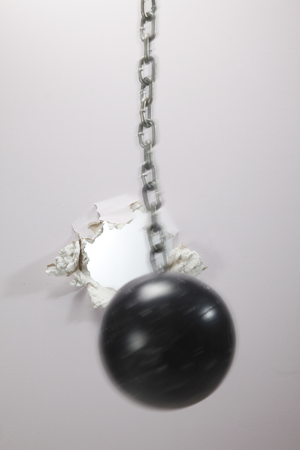 metal ball cracking down a wallの写真素材