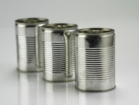 aluminium can in a row on the plain backgroundの写真素材
