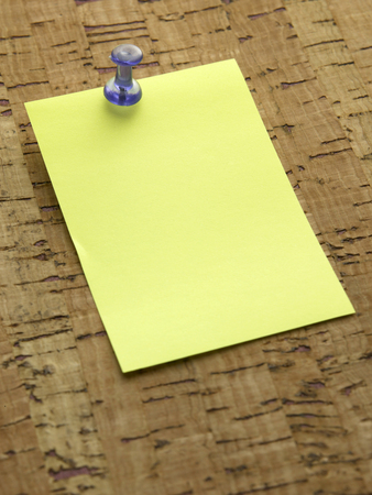 blue pin with note pinned to cork noticeboardの写真素材