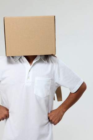 Man with a carton box on headの写真素材