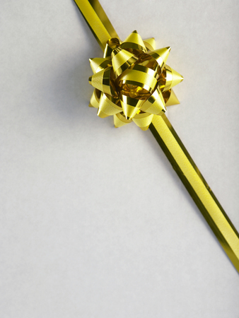 close up the yellow color ribbon on the white boxの写真素材