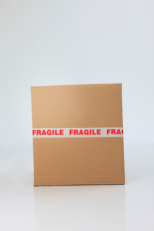 brown cardboard box sealed with fragile signの写真素材