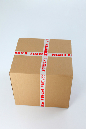 brown cardboard box sealed with fragile signの写真素材