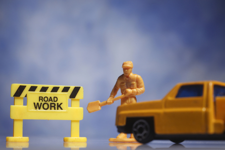 Figure halting a car from entering a construction site.の写真素材