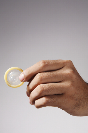 stock image of the man holding condomの写真素材