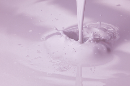 pouring paint or pink  liquid created splashの写真素材