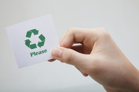man holding a message-recycle pleaseの写真素材