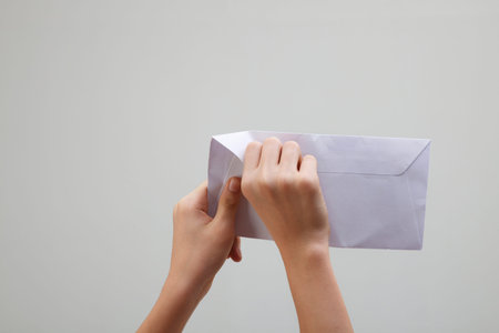 man open a white envelope