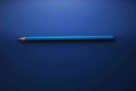 blue color pencil on the blue backgroundの写真素材