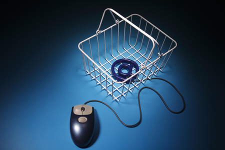 wire basket with @ on the blue backgroundの写真素材