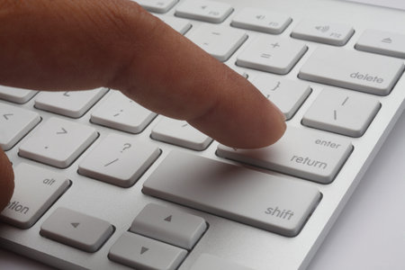 close up of the finger  typing on the keyboard