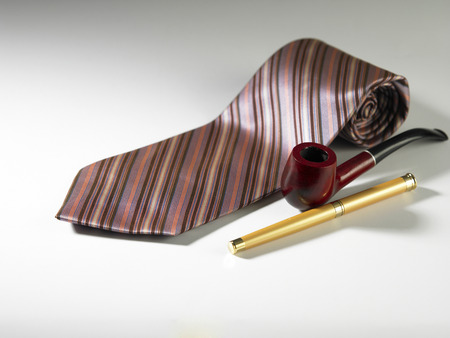 pen pipe and necktie on the plain backgroundの写真素材