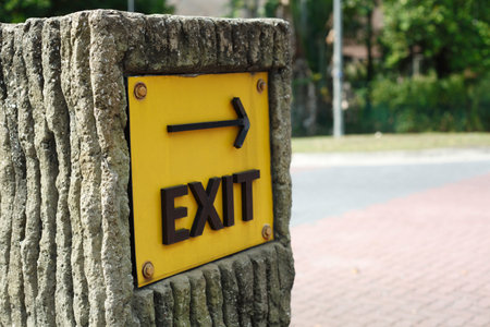 yellow exit sign on the road side