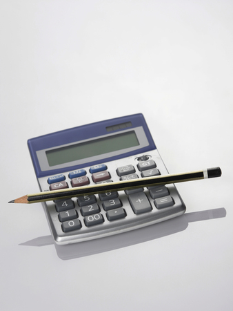 pencil resting on the calculatorの写真素材