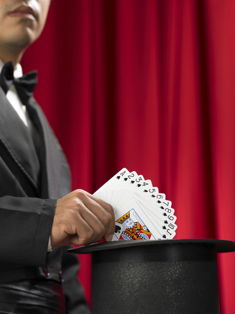 Magician make performance with card deck and top-hatの写真素材