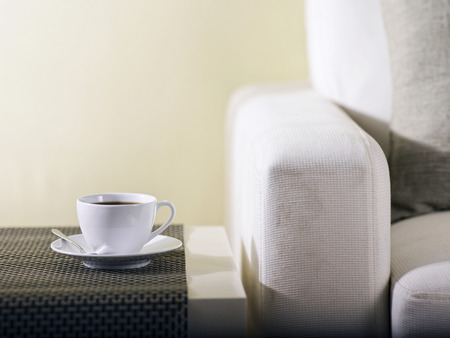 Coffee on a table next to a couchの写真素材