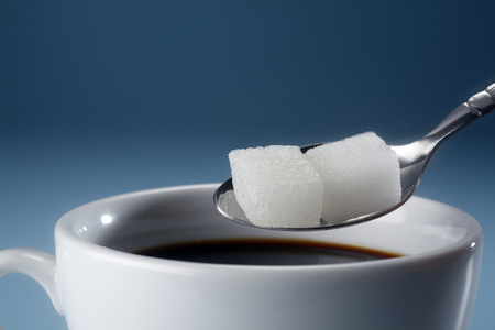 stock image of adding sugar to coffeeの写真素材