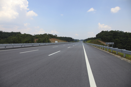 Straight road through green landscapeの写真素材