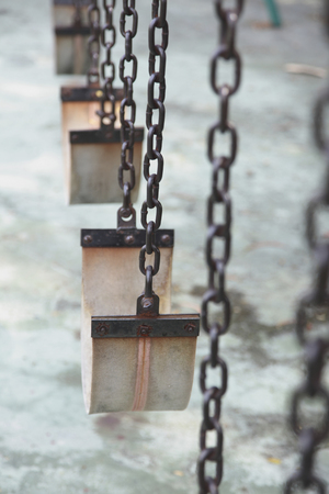 close up of swings at an empty playgroundの写真素材