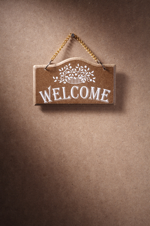 Welcome sign hung on background.の写真素材