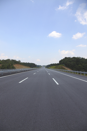 Straight road through green landscapeの写真素材