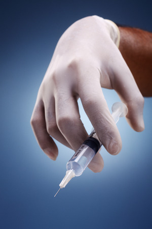 A person holding a syringe.の写真素材