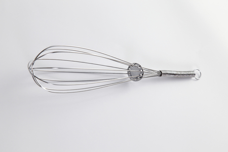kitchen utensil -whisk on the plain backgroundの写真素材